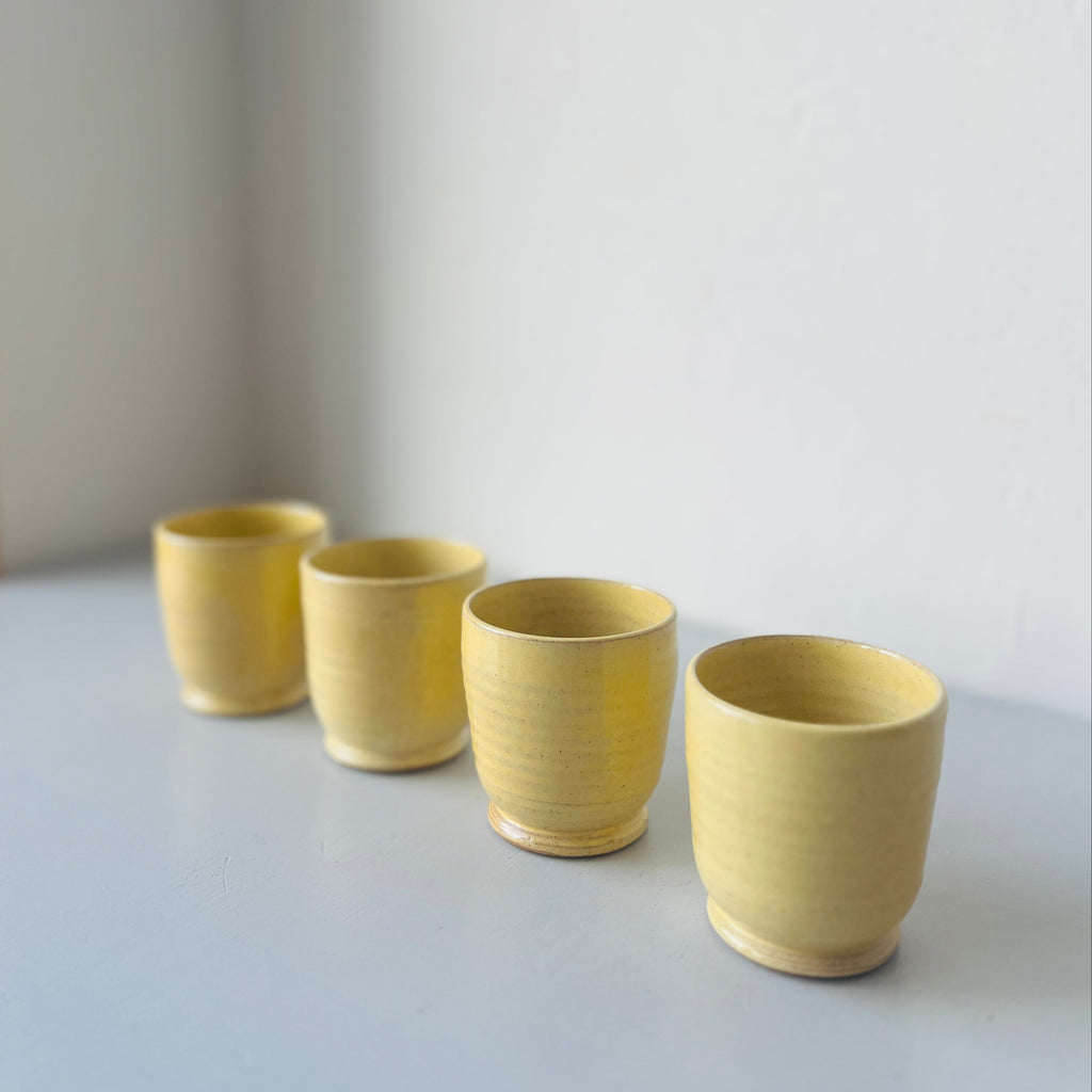 Set of 4 handmade ceramic butter yellow cups