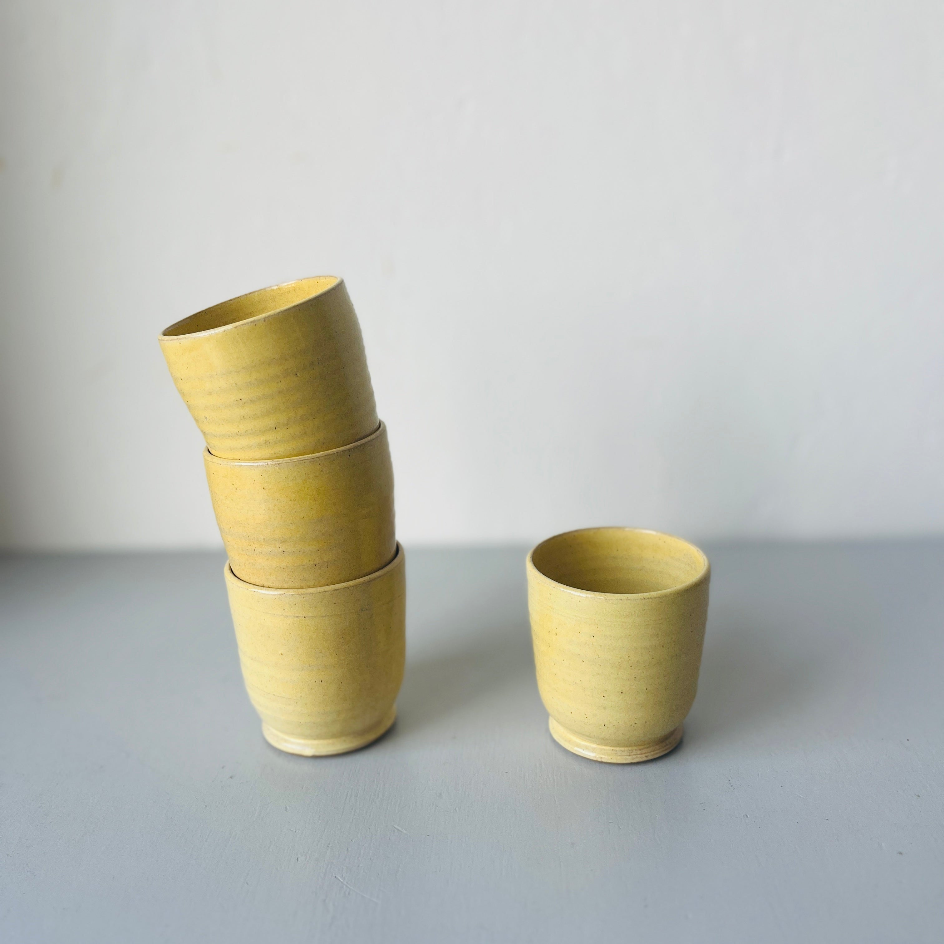 Set of 4 handmade ceramic butter yellow cups
