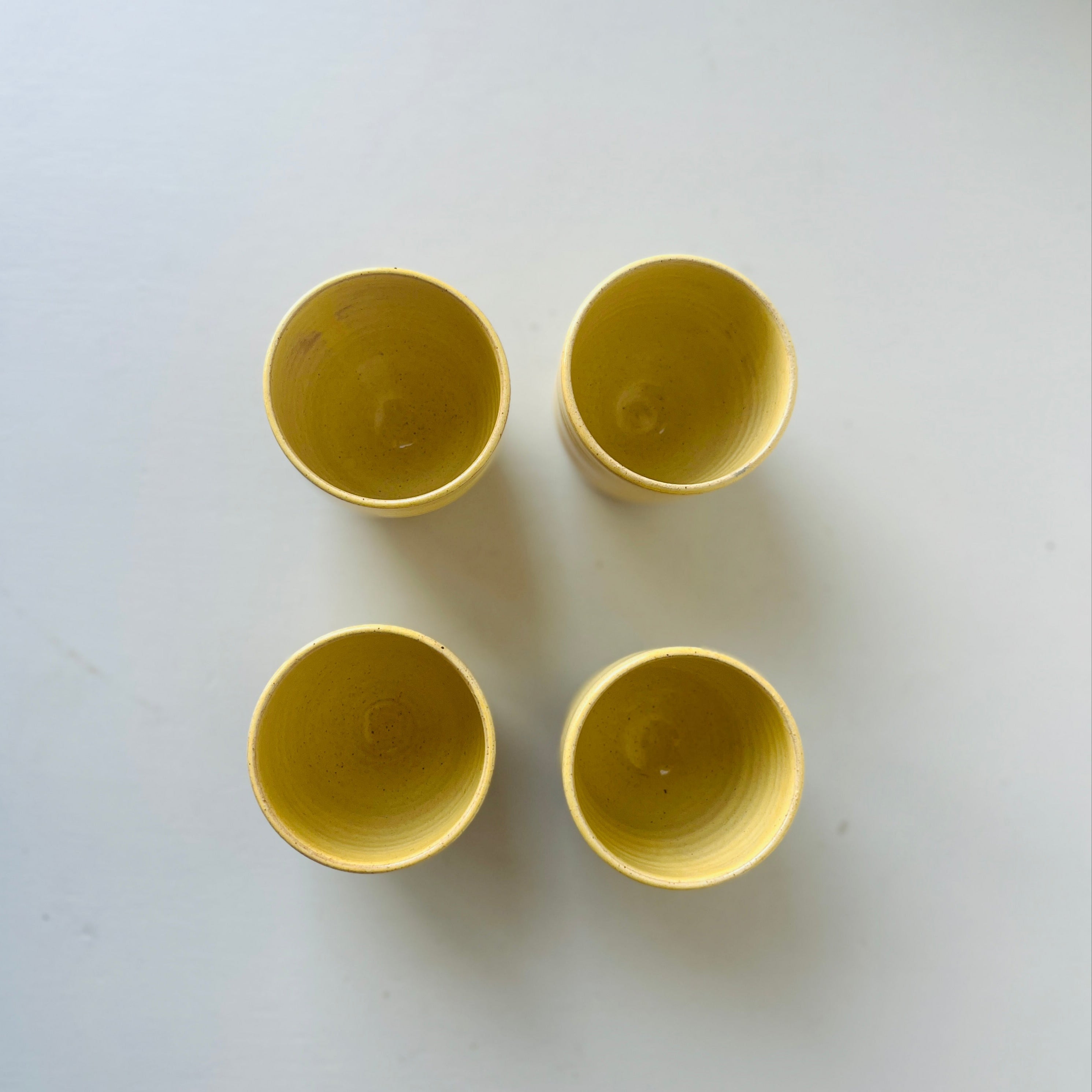 Set of 4 handmade ceramic butter yellow cups