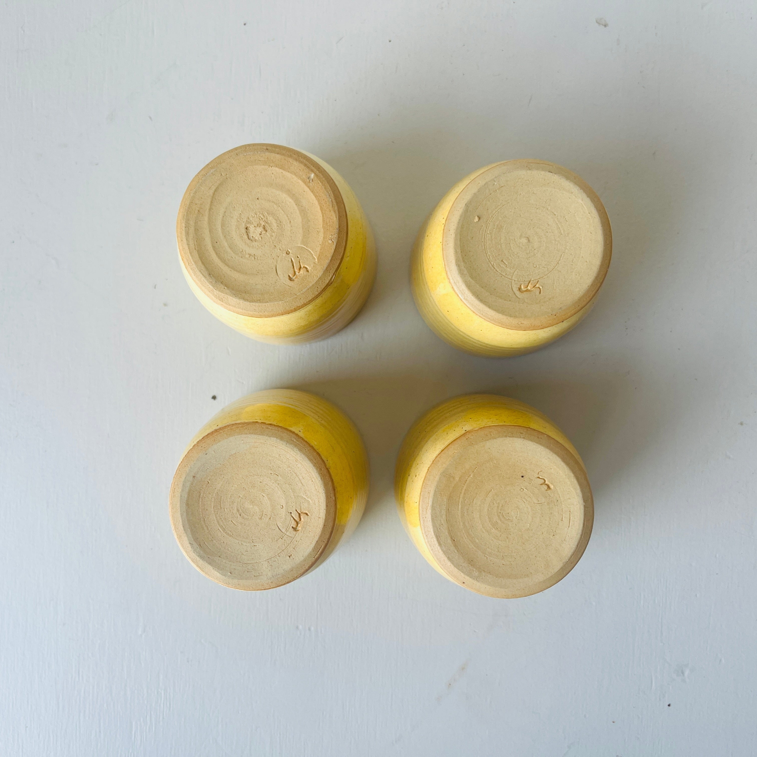 Set of 4 handmade ceramic butter yellow cups